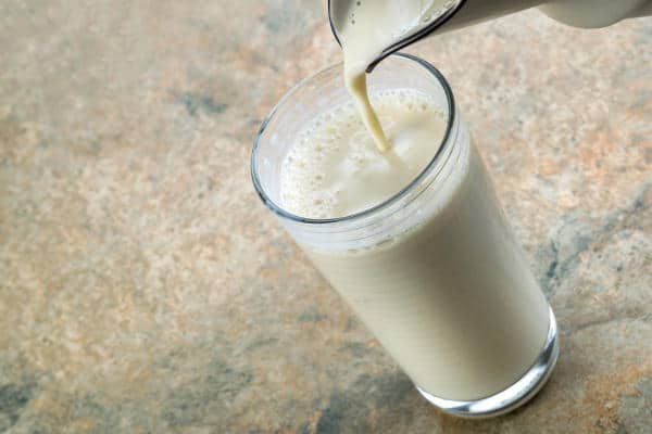 Pouring plant-based milk into a glass
